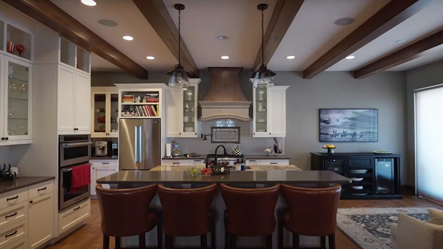 Modern kitchen with pendant lights, recessed ceiling lights, and island seating