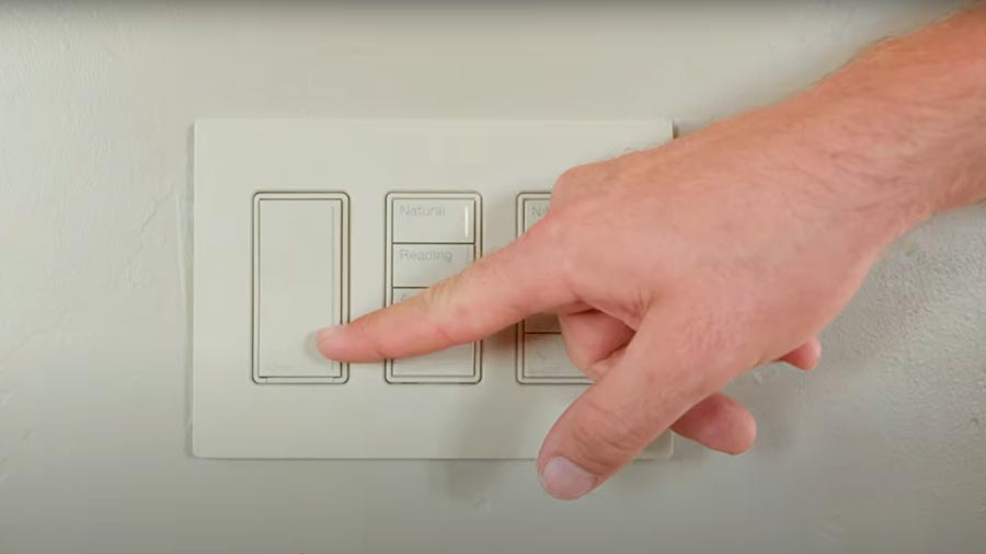 Hand pressing modern wall-mounted light control keypad