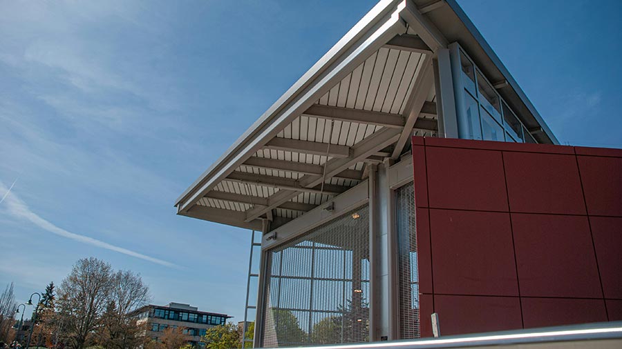 Modern architectural structure with a slanted roof against a clear blue sky