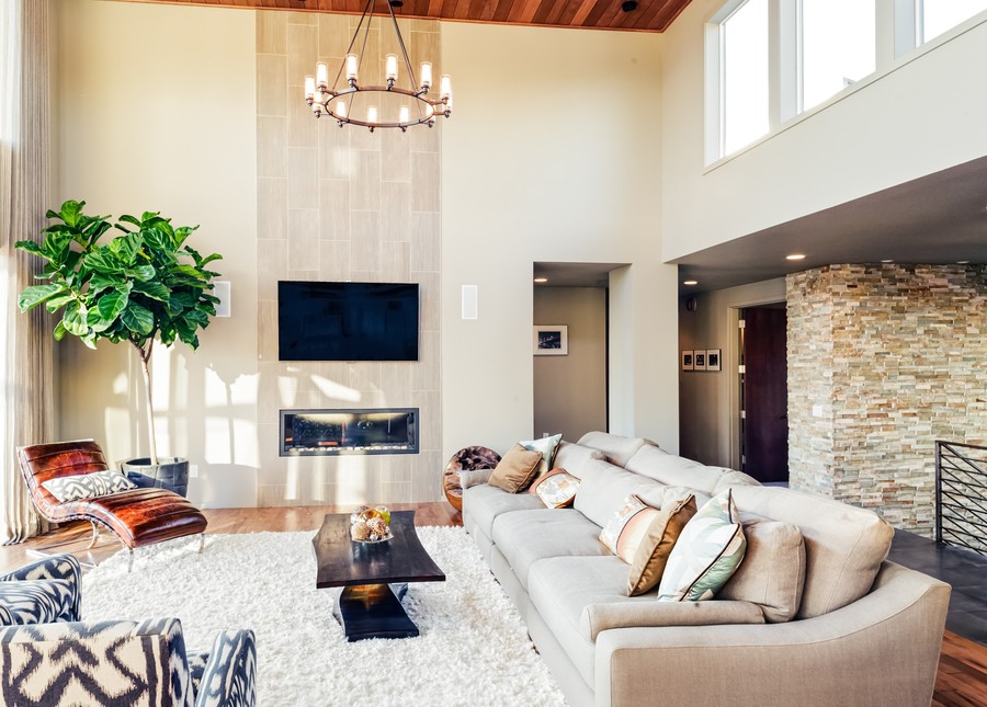 A living room featuring in-wall speakers and a wall-mounted TV.