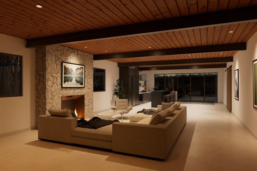 A softly illuminated living area with a sectional and a lit fireplace.