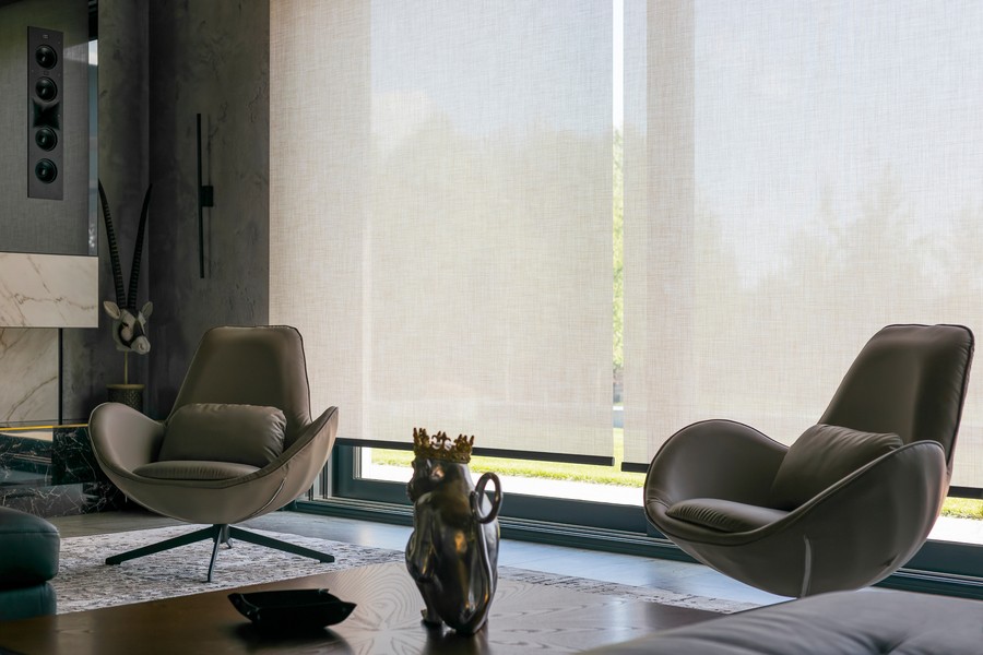  Image is of a smart home with modern motorized blinds on each window.