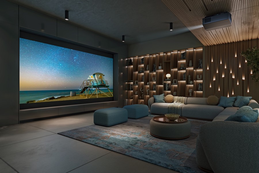 A casual home theater with a sectional, large screen, and Sony projector.