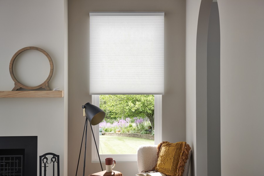 Lutron honeycomb shades partially lowered in a living room