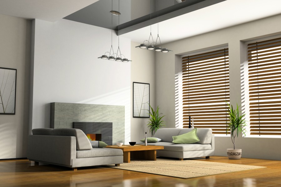 A living room showcasing couches, coffee table, and motorized shades. 