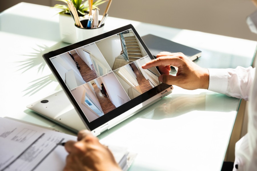 A person watching security footage on a tablet. 