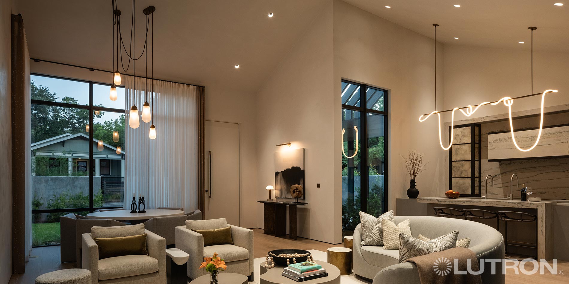Modern living room with ambient lighting and large windows, showcasing smart lighting design
