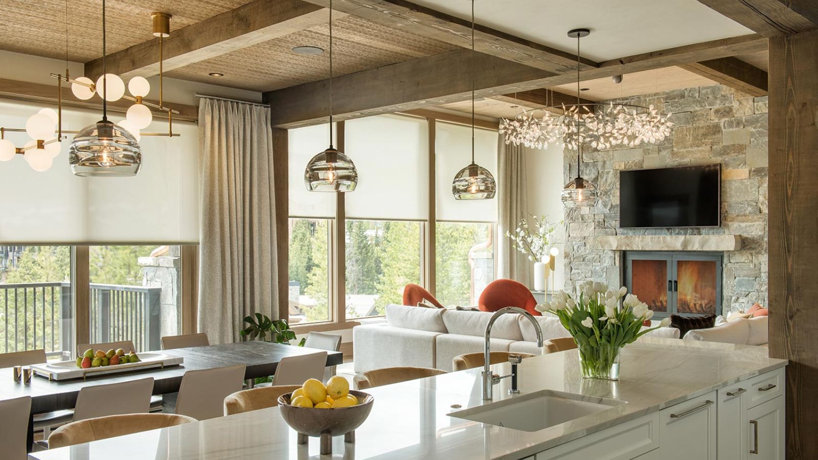 Rustic-modern kitchen and living area with pendant lights and fireplace