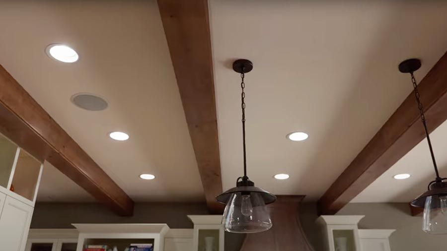 Recessed ceiling lights with wood beams and glass pendant lamps